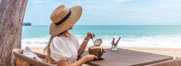 woman dines at waterfront restaurant